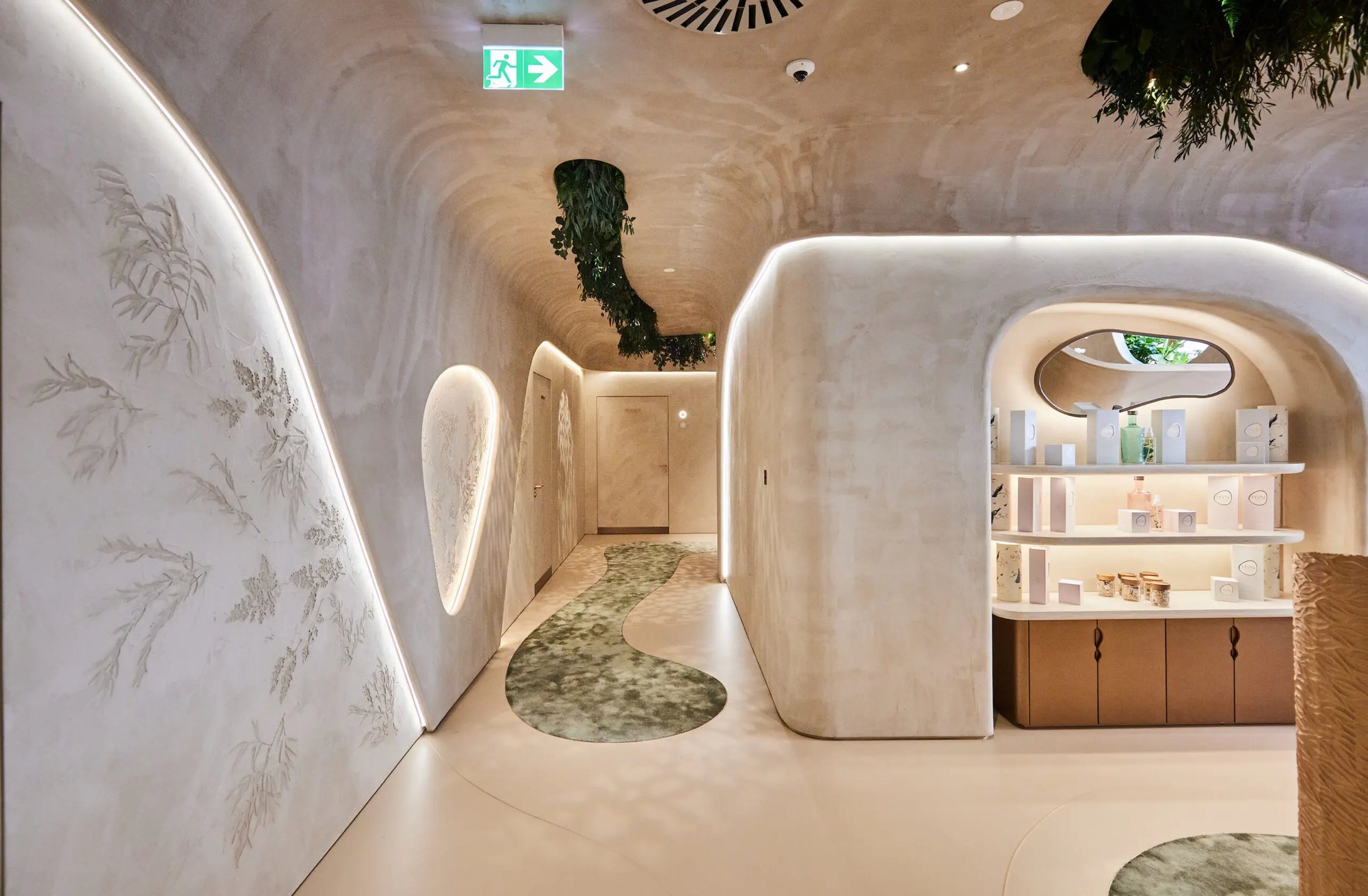 HVN Knightsbridge treatment corridor by SheridanCX, botanical bas-relief walls, backlit organic curves and an illuminated product niche