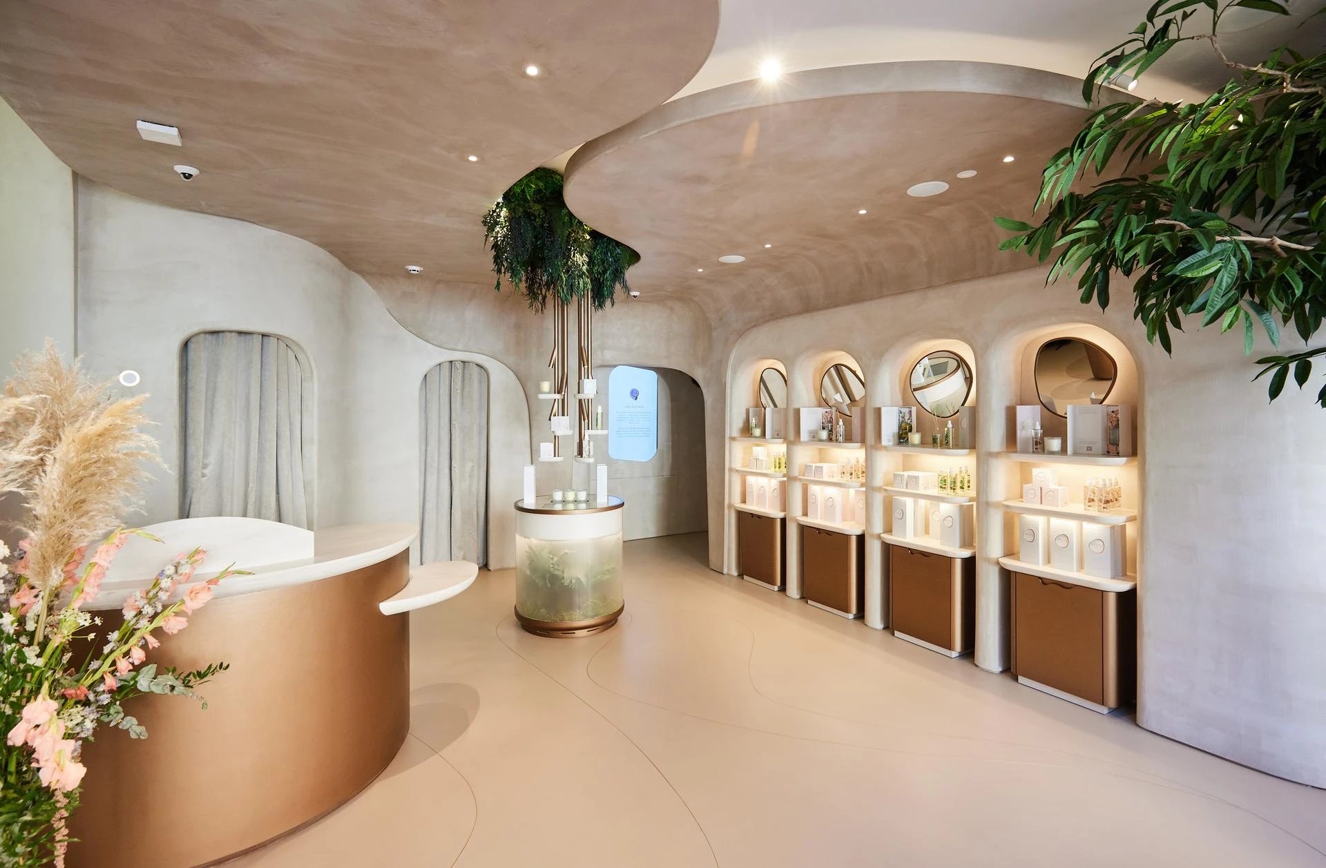 HVN Knightsbridge reception and product wall designed by SheridanCX, curved bronze desk, arched niches and biophilic detailing