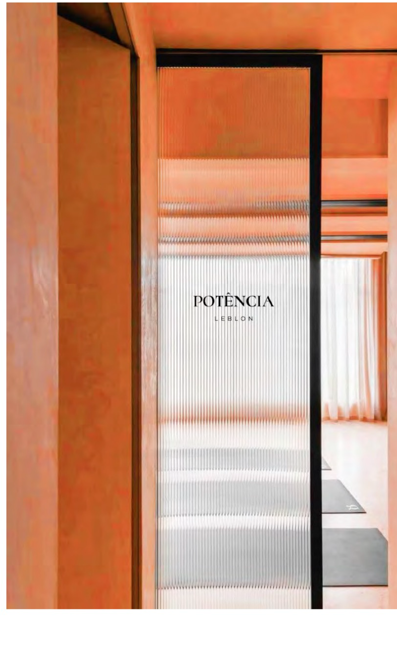 Fluted glass studio door with etched Potência Leblon signage