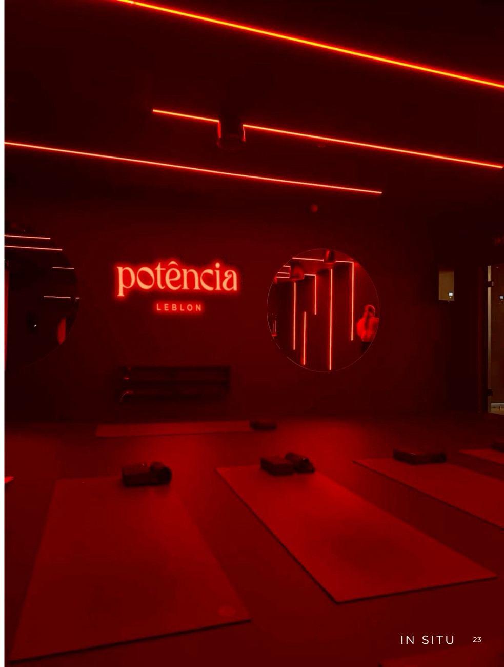 Glowing potência neon sign in the red-lit Pilates studio